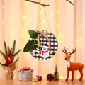 Close-up of Christmas door sign with snowman on buffalo plaid base and festive decor - Grey Snowman