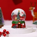 Detailed view of a Christmas snow globe with Santa Claus, pine tree and a red cabin base - Medium No Light - Style A