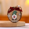 Detail of wooden Christmas ornament with Noel text, gnome graphic and red plaid bow - Green Hat Gnome
