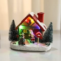 Lighted Christmas resin house ornament with Santa figure and festive snowy landscape scene - Red Roof (Glowing)