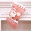 Pink velvet Christmas stocking with 3D Santa Claus and gold sequins hanging on fireplace - Santa Claus