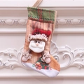Classic Christmas stocking with 3D Santa Claus applique and plaid trim on a white wall - Santa Christmas Sock