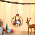 Festive wooden gnome ornament hanging on a tree branch with warm bokeh background lights - Red Hat Gnome