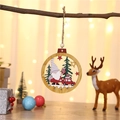 Wooden Christmas ornament featuring Santa in a car, hanging on a branch with bokeh lights - White Hat Gnome