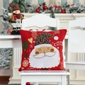 Close-up of red Christmas gnome pillow cover on white chair with festive decor - Red Santa Claus