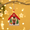 Wooden Christmas nutcracker house ornament hanging on a festive golden branch - House Style / Natural Wood Red