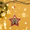 LED wooden star ornament with nutcracker illustration hanging on Christmas tree branch - Five-pointed Star / Natural Wood Red