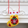 Close-up of yellow felt DIY Christmas stocking with red star and snowflake details - Christmas Ball Style (Yellow)