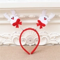 Detail of red velvet Christmas headband with white plush reindeer on silver springs - Deer