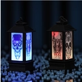 Close-up of Halloween lantern showing skull patterns in blue and red LED light modes - Skull