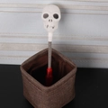 Skeleton head spring stick with red handle in a woven basket for Halloween decor - Shaking Wand (Skull)