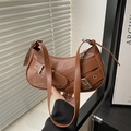 Brown faux leather baguette bag with metal buckles and eyelets in a vintage industrial style - Brown