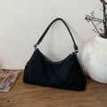 Vintage black suede baguette bag with contrast white stitching on a rustic wooden table - Black