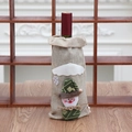 Close-up of burlap Christmas wine bottle cover featuring a 3D snowman and snowflake - Khaki