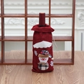 Close-up of burlap Christmas wine bag with a 3D snowman and festive plaid hat detail - Red