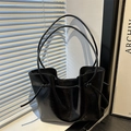 Polished black tote bag with long double straps and drawstring knot details for women - Black