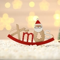 Detail of wooden Xmas sign with Santa Claus, birds, and red rocking base for Christmas decor - Santa Claus