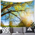 Lush green forest landscape tapestry hanging over a gray fabric sofa as wall decoration - 15