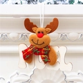 Close-up of reindeer plush ornament with NOEL wooden sign hanging on white fireplace - Reindeer (NOEL)