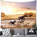 Detailed view of an African elephant sunset tapestry hung above a modern gray sofa - 100X70 / Savanna Sunset Elephant Zebra (Style 9)