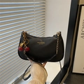 Black pebbled leather shoulder bag with gold chain and a red cherry charm detail - With Pendant / Black