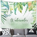 Detail of tropical monstera leaf tapestry with watercolor text hung over a gray sofa - Watercolor Green Tropical Plants (3)