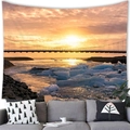 Modern wall tapestry featuring a vibrant sunset seascape above a cozy grey living room sofa - Glacier Long Bridge (9)