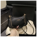 Detail of black lychee leather crescent bag with gold chain and HUA JIAO logo in gift box - Black