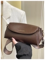 Detail of retro brown leather pillow bag with wide herringbone strap and gold lettering - Basic Style / Coffee
