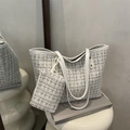 White tweed tote bag with matching pouch and slender shoulder straps on art display stand - White