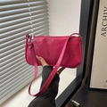 Glossy magenta patent leather baguette bag shown in a minimalist window setting - Rose Pink
