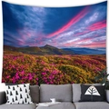 Detailed mountain valley flower field scenery wall tapestry displayed over a modern sofa - 100cmx70cm