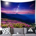 Close-up of a floral tapestry hanging over a sofa featuring a starry night sky and mountains - 100cmx70cm