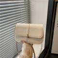 Minimalist beige matte leather baguette bag with a gold buckle and shoulder strap - White