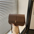 Deep brown matte leather saddle bag with gold cylinder buckle and adjustable strap - Brown