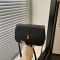 Elegant black faux leather baguette bag with golden clasp and adjustable shoulder strap - Black