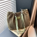 Olive green corduroy tote bag with leather strap and metal rings in a minimalist setting - Green