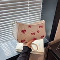 Chic white cherry print shoulder bag with gold hardware and stylish curved silhouette - White