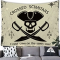 Detail of nautical pirate tapestry with skull and scimitars over a modern sofa - Pirate Skull Scimitars Style
