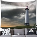 Lighthouse wall tapestry featuring a dramatic sunset scene hanging over a gray sofa - 18 / 100x70(Peach Skin)