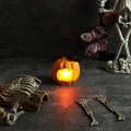 Close-up of glowing orange Halloween pumpkin lantern with black bat and LED light - Open Mouth Pumpkin Lantern
