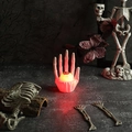 Detail of Halloween LED glowing eyeball held by a skeleton hand with spooky lighting - White Eye Skeleton Hand Light