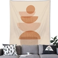 Detail of Nordic geometric wall tapestry on living room wall above a grey sofa - Bohemian Layered Semi-circles (14)