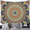 Geometric mandala tapestry with coral and blue patterns hung above a grey fabric sofa - Mandala Style 12 (12)