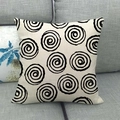 Linen cushion cover with black spiral patterns on a grey sofa in a minimalist living room - Spiral Circles / 45x45cm