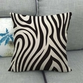 Close-up of black and white zebra pattern linen pillow cover on a grey sofa - Wavy Zebra Print / 45x45cm