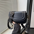 Classic black crossbody bag with triple stitching and wide strap in natural light - Black