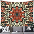 Detail of warm orange bohemian mandala tapestry showing intricate floral patterns on a wall - Mandala Style (9)