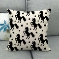 Linen cushion cover featuring black unicorn and stars print on a grey sofa - Unicorn All-over Print / 45x45cm