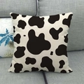 Linen square pillow cover featuring black and white cow print on a grey sofa - Minimalist Cow Pattern / 45x45cm